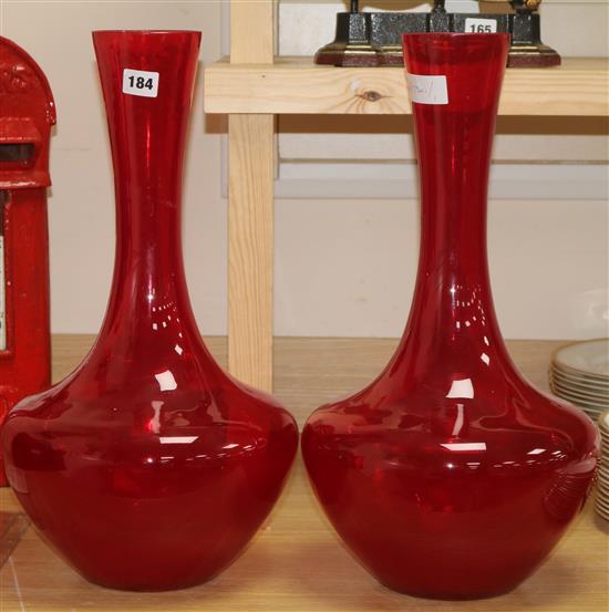 A pair of red glass vases height 51cm